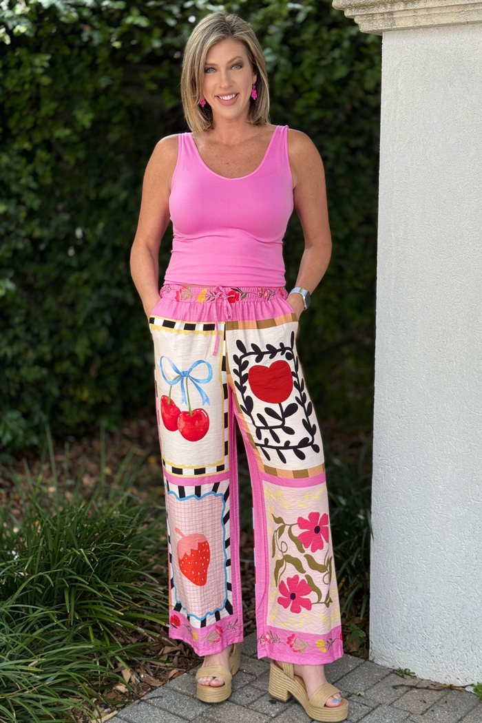 Colorful cherry and patchwork print pants with elastic waist styled with pink tank