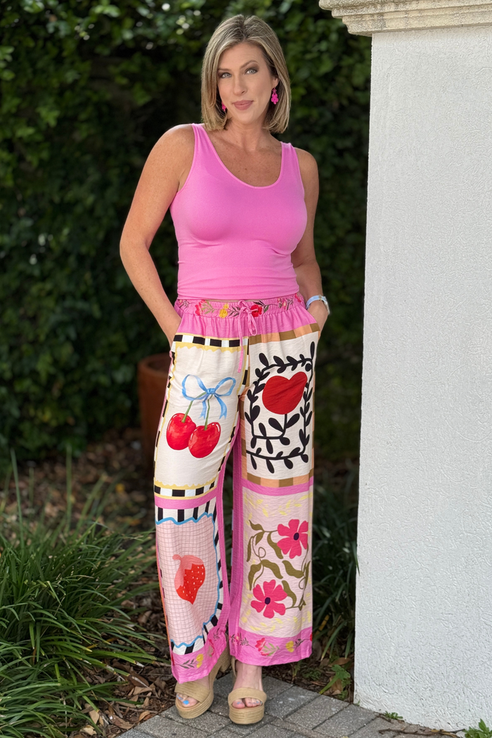 Back view of vibrant Italian patchwork pants with fruit and dove graphics
